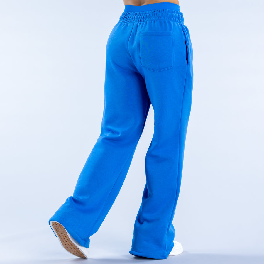 Blue wide-leg joggers with back patch pockets and elastic waistband, wide cuffed hem
