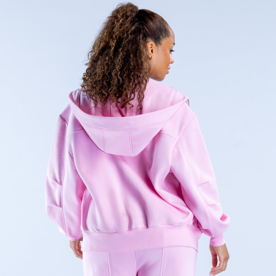 Pink zip-up hoodie with hood, kangaroo pocket, and ribbed cuffs