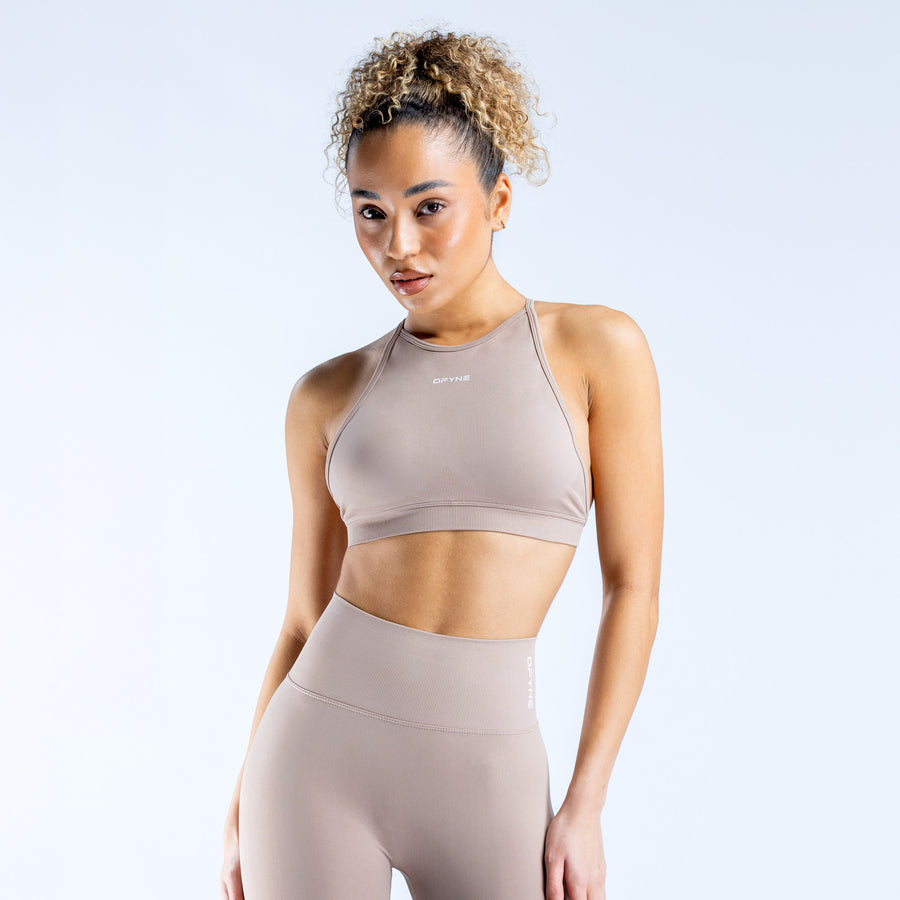 Taupe high-neck sports bra with smooth racerback fit