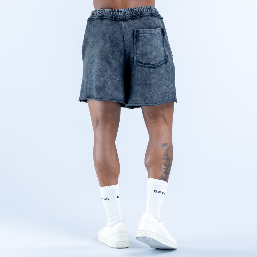Washed navy-blue denim shorts with elastic waistband, back pocket, and hem stitching