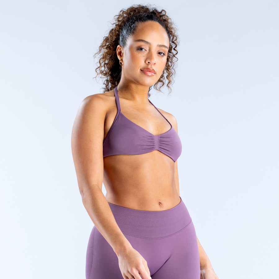 Impact strappy bra in purple, front view with V-neck and ruched center