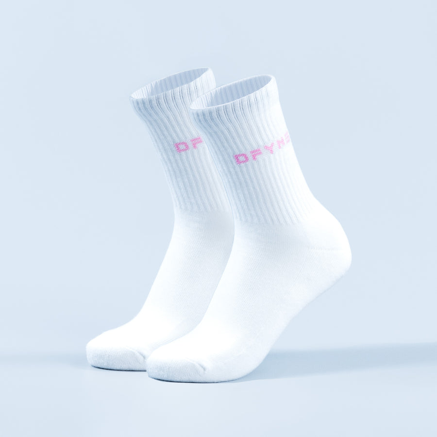 White crew socks with pink logo lettering on the side, ribbed knit cuff