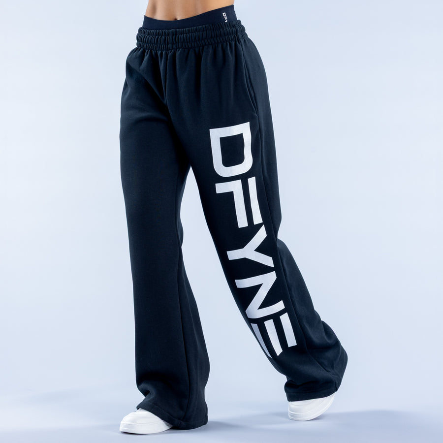 Wide-leg jogger pants with elastic waistband and large white logo lettering on leg