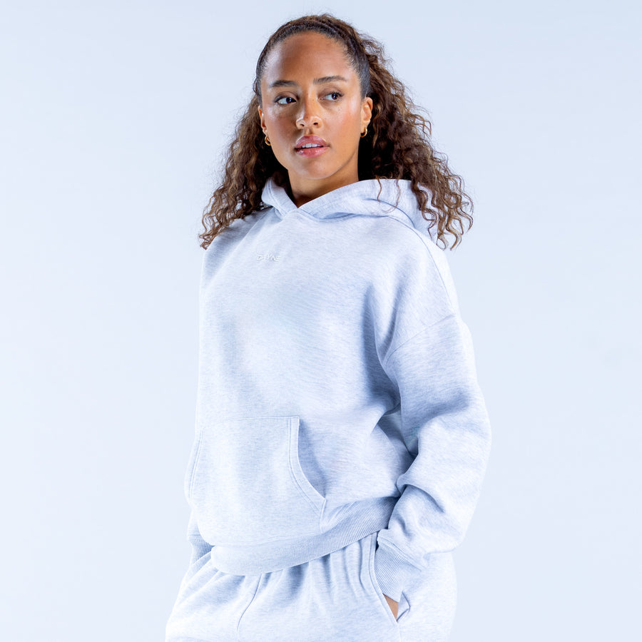 Light blue pullover hoodie with hood and kangaroo pocket, front quarter view
