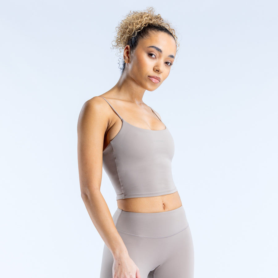 Light gray strappy crop top with thin straps and fitted cropped length