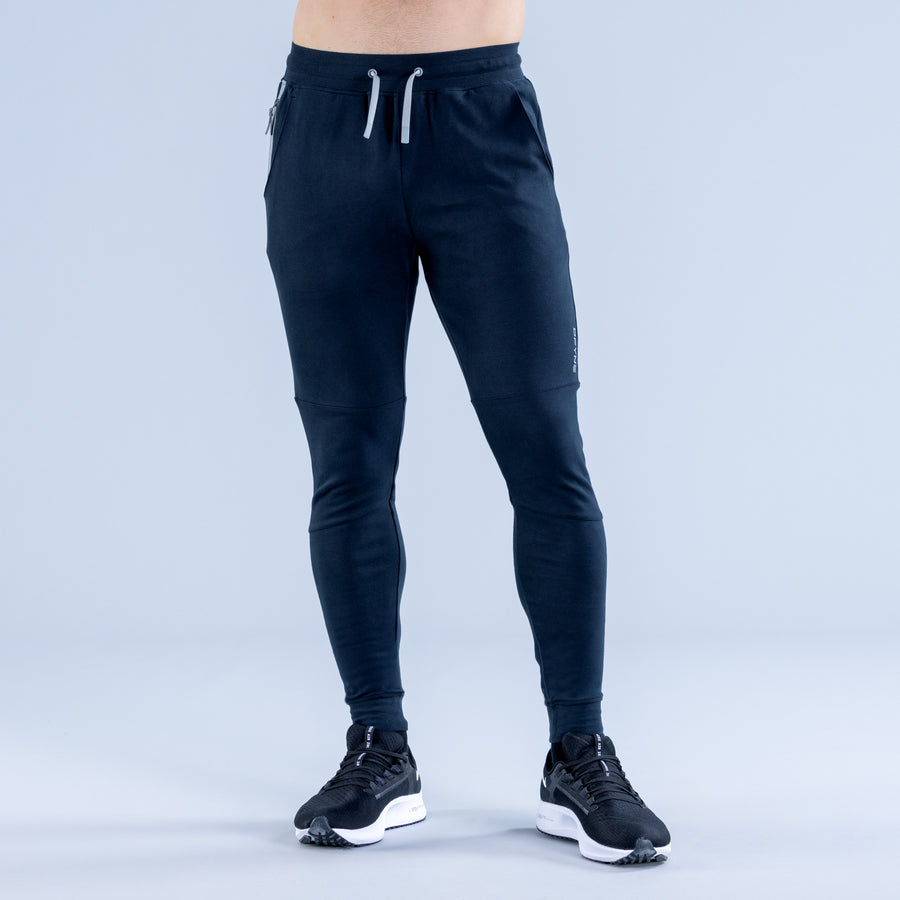 Dark navy tapered joggers with drawstring waist and ankle-length slim fit