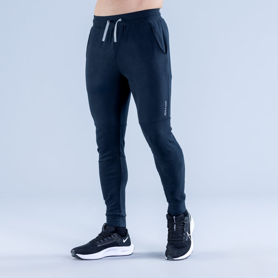Dark navy tapered joggers with side zip pocket and white drawstring
