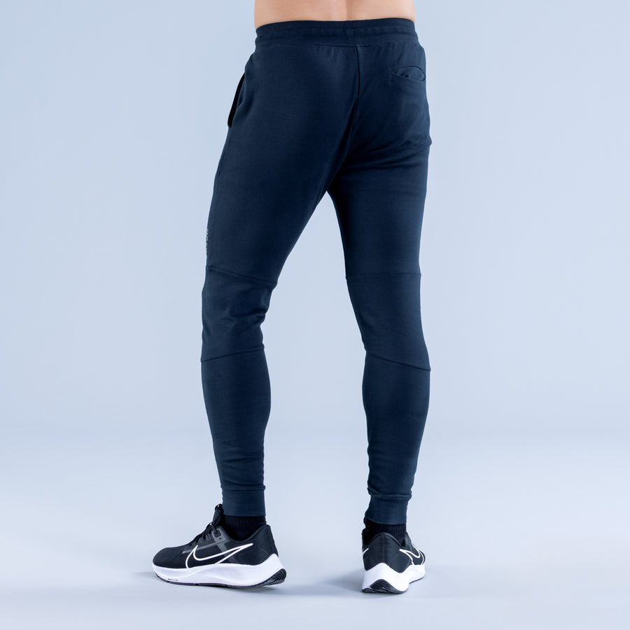 Dark navy tapered jogger pants with elastic waist and cuffed ankle