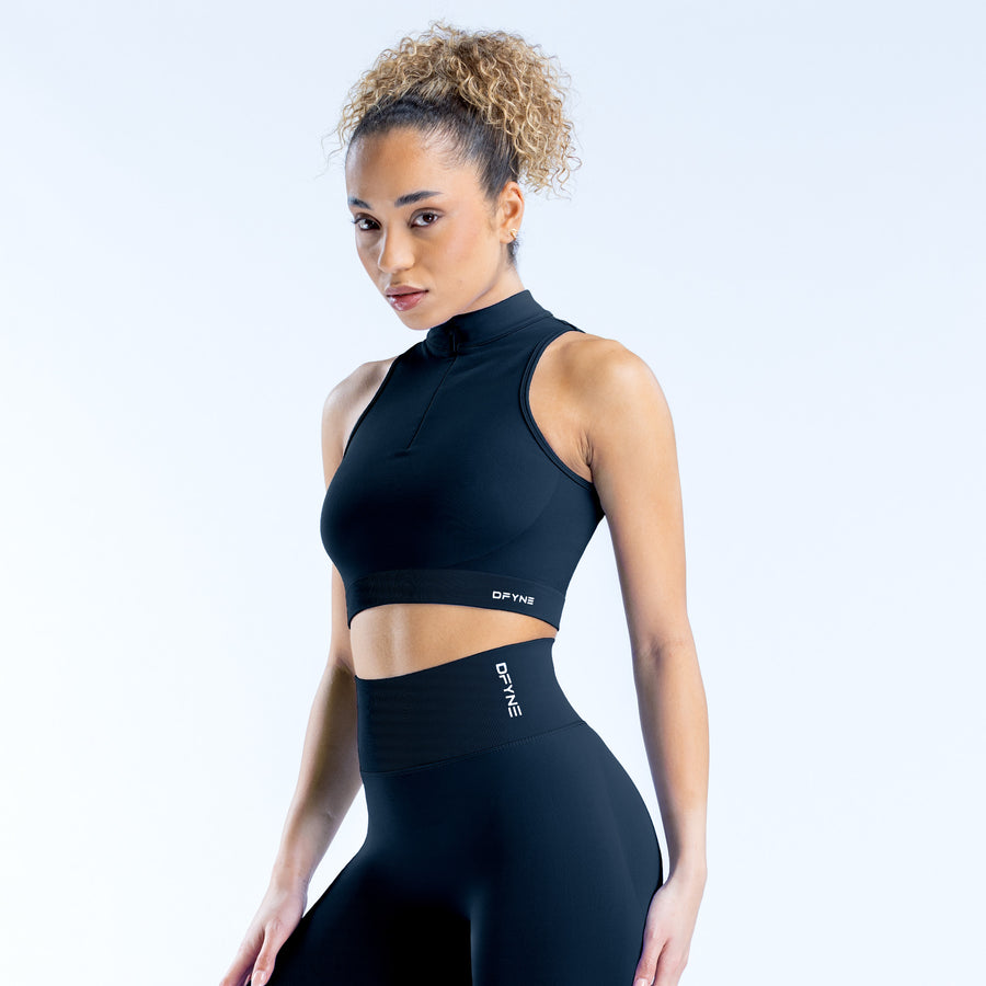 Black dynamic quarter-zip tank top with sleeveless cut and high neck, cropped fit