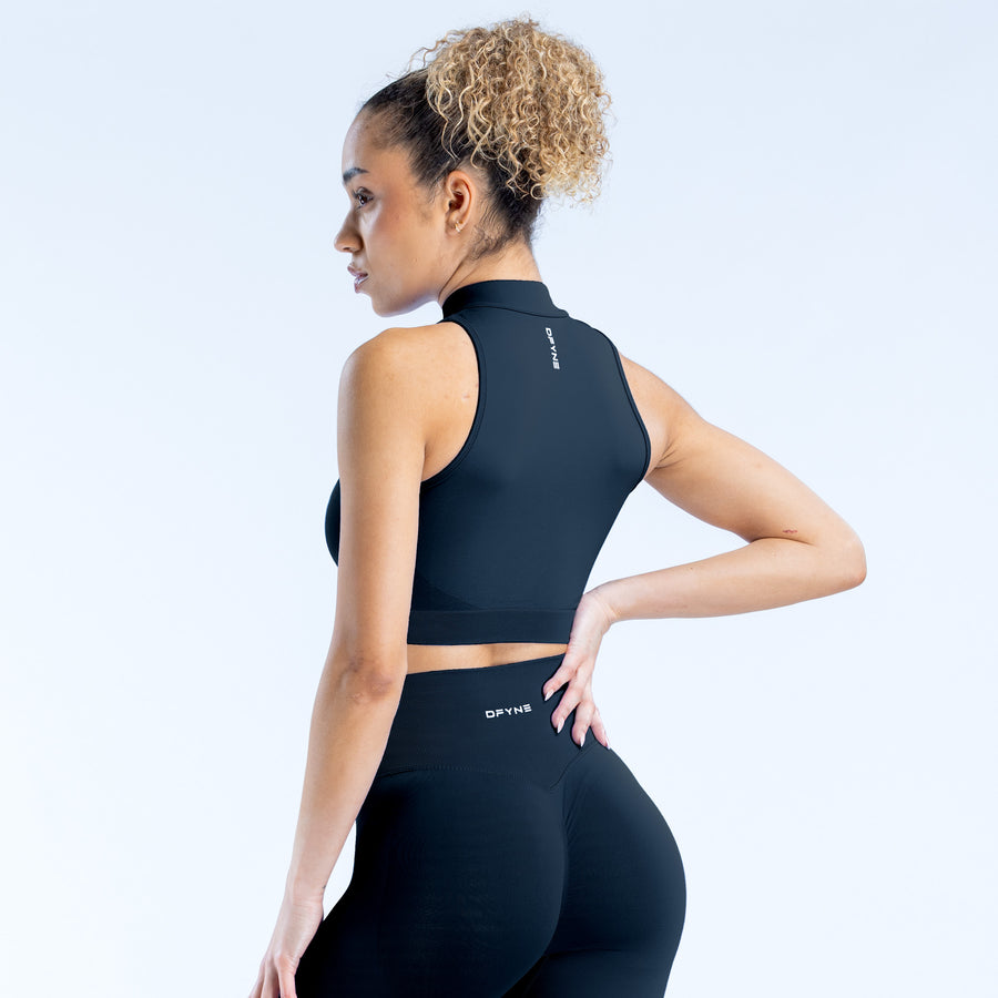Black dynamic quarter-zip tank top with racerback and high neck, logo at back hem