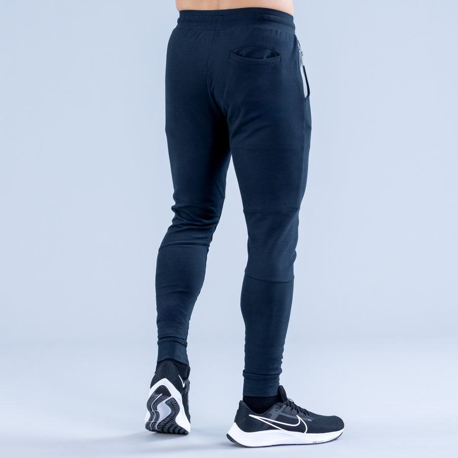Dark navy tapered joggers with back patch pocket and drawstring hem