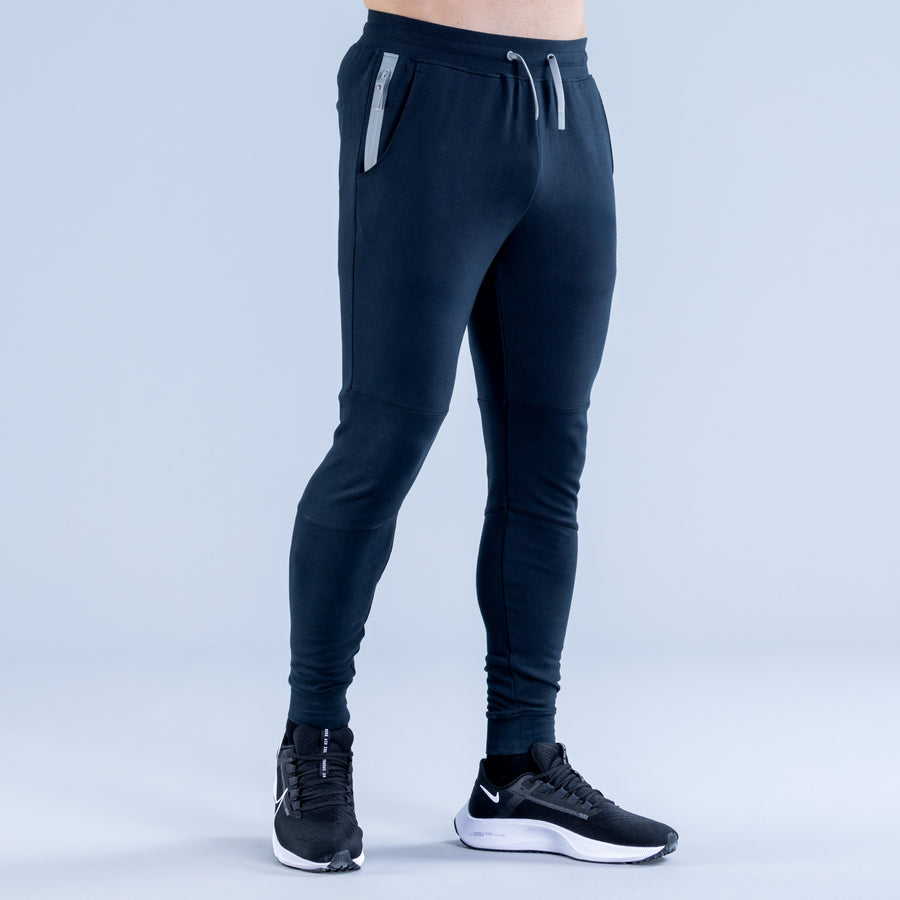 Dark navy tapered jogger with drawstring waistband and slanted side pockets
