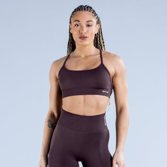 Dark plum sports bra with smooth wide band and DPYNE logo