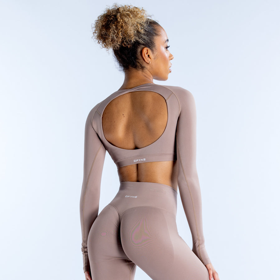 Mauve long-sleeve crop top shown from back with open back and racer-style seam