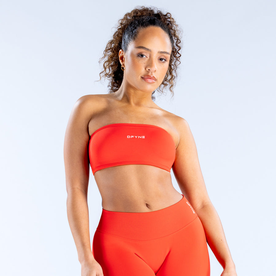 Backless bandeau sports bra in red with wide neckline and small chest logo