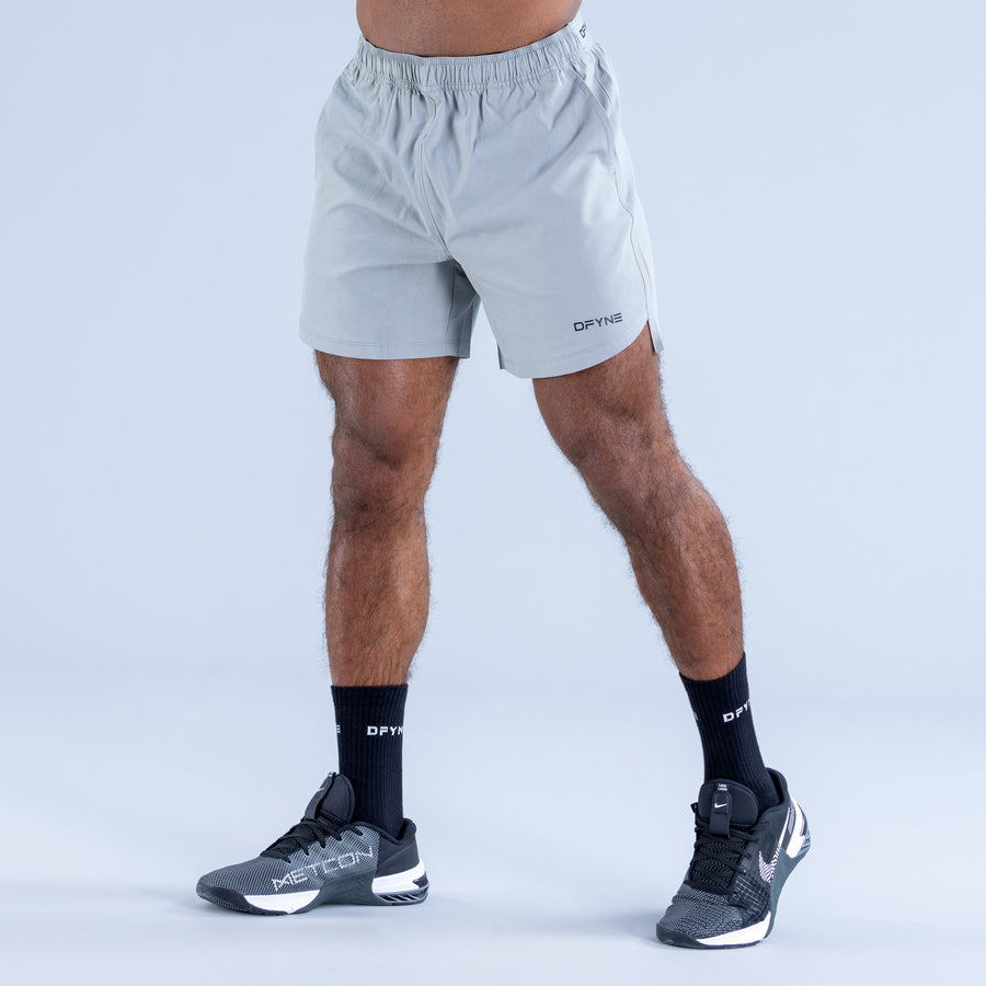 Light blue training shorts with elastic waistband and DPYNE logo on leg