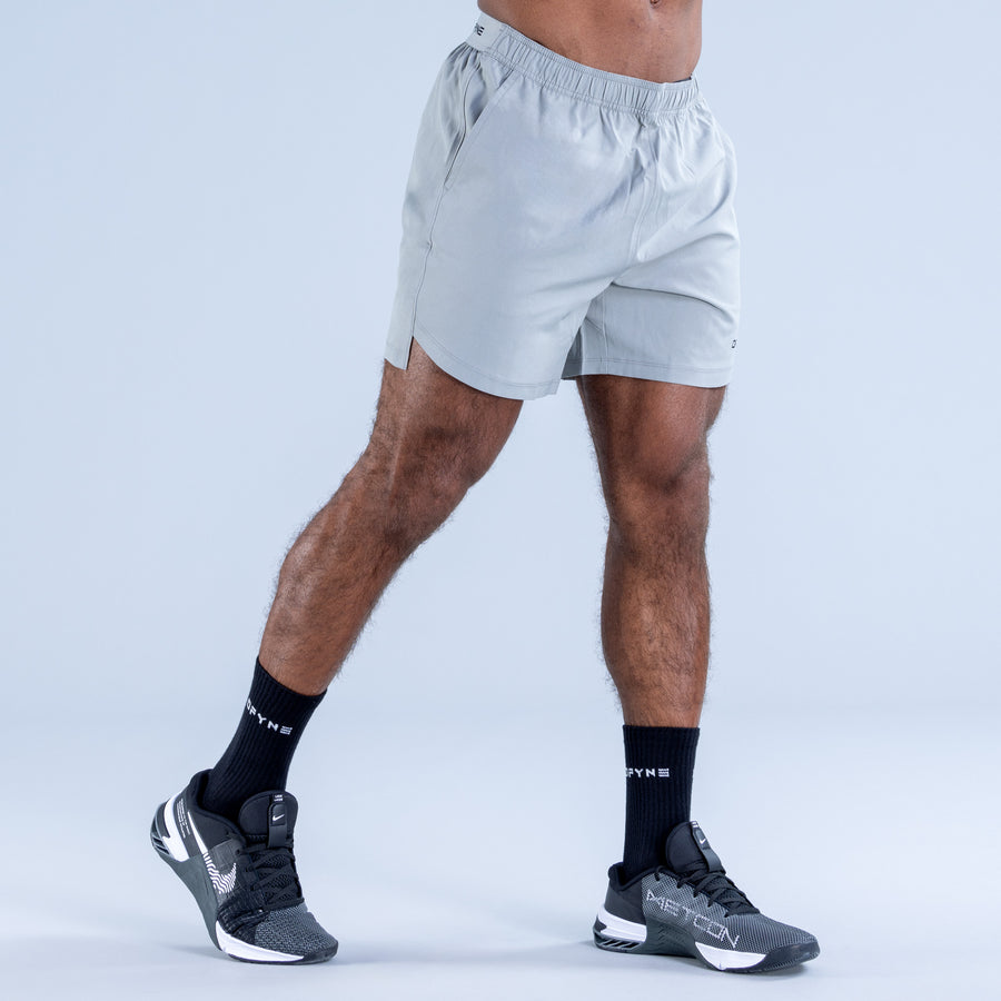 Light blue training shorts with elastic waistband and DPYNE logo on the leg