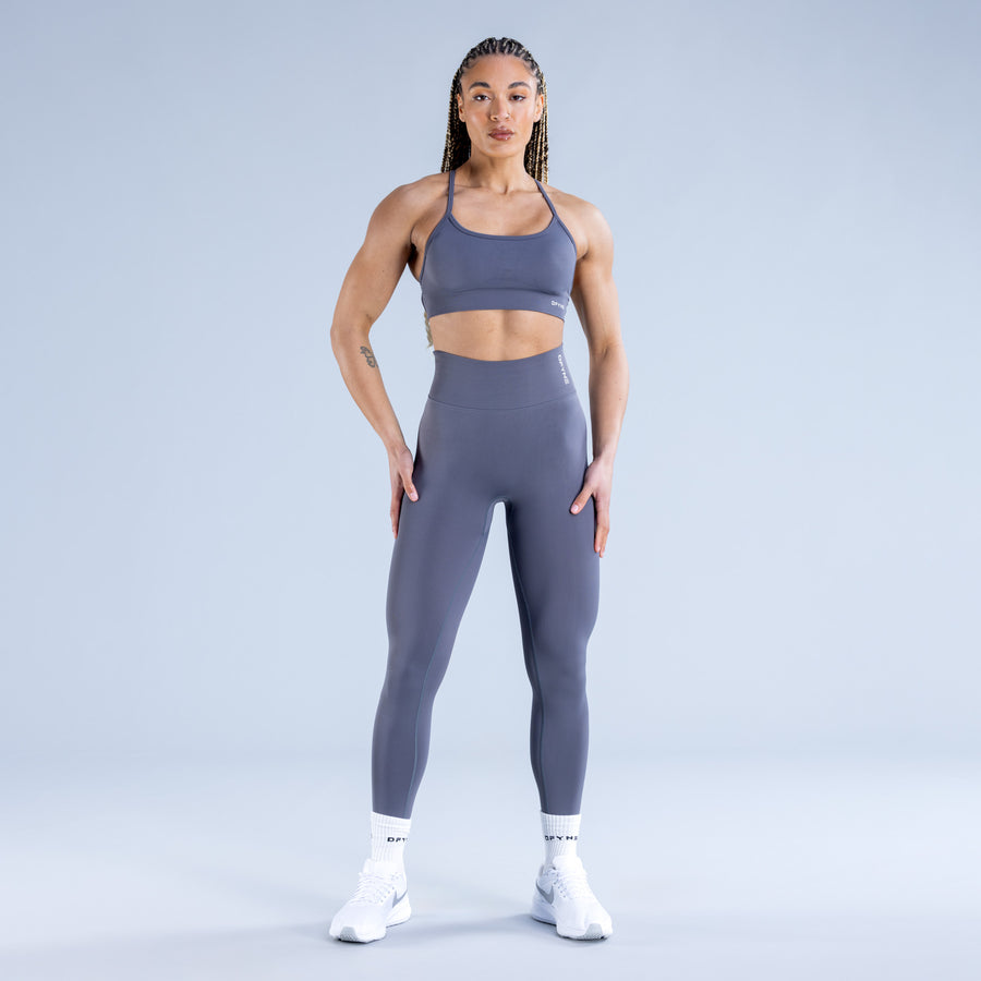Backless sports bra in muted blue with wide scoop front and thin shoulder straps