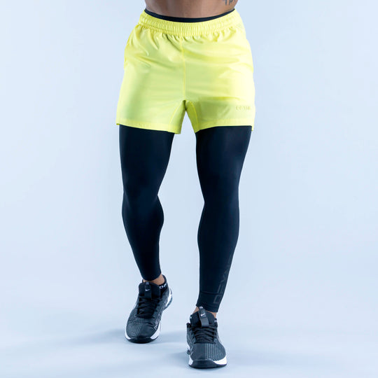 Two-tone compression base layer bottoms with neon yellow waistband and black fitted legs