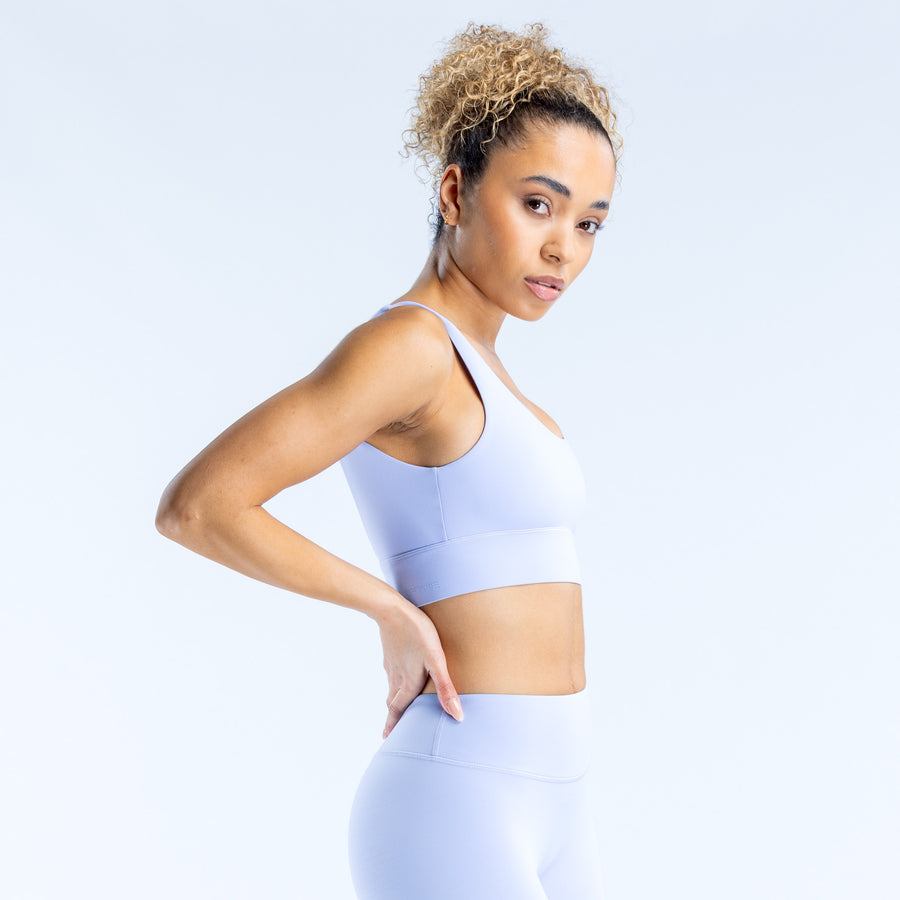 Light blue sports bra with racerback straps and smooth supportive fit