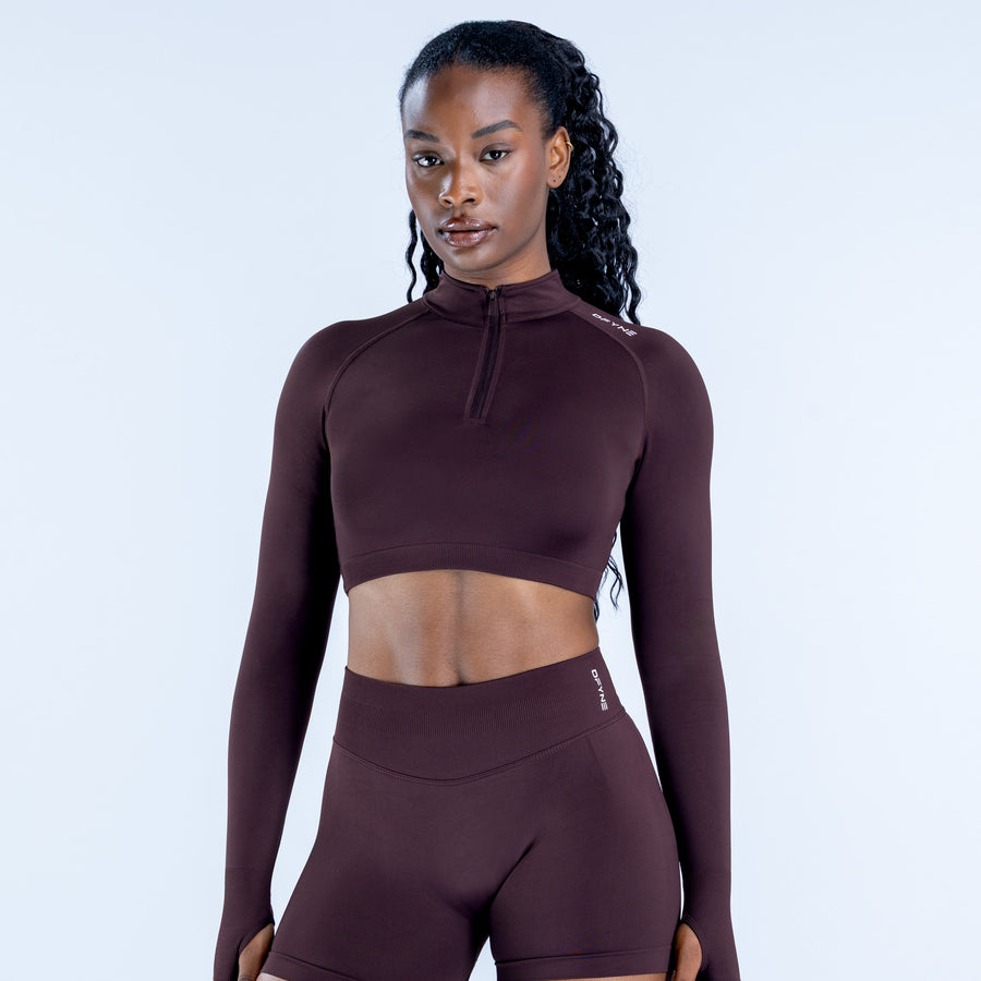 Dark plum cropped zip athletic top with long sleeves and high neckline
