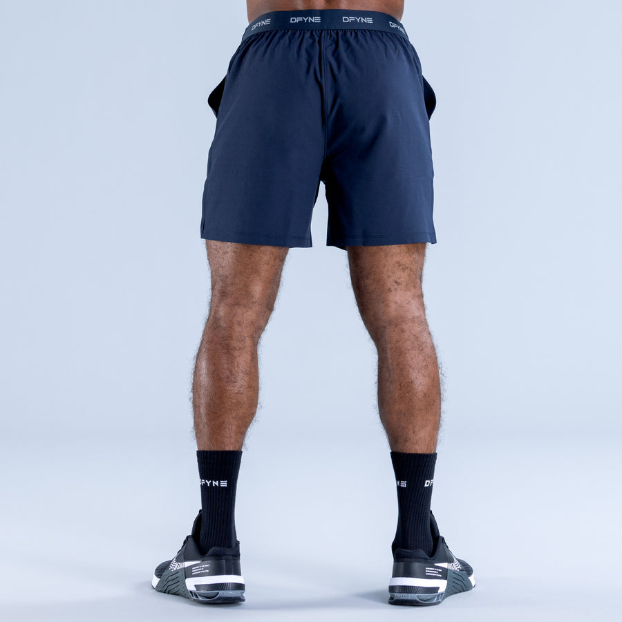 Navy training shorts, back view with elastic waistband and above-knee hem