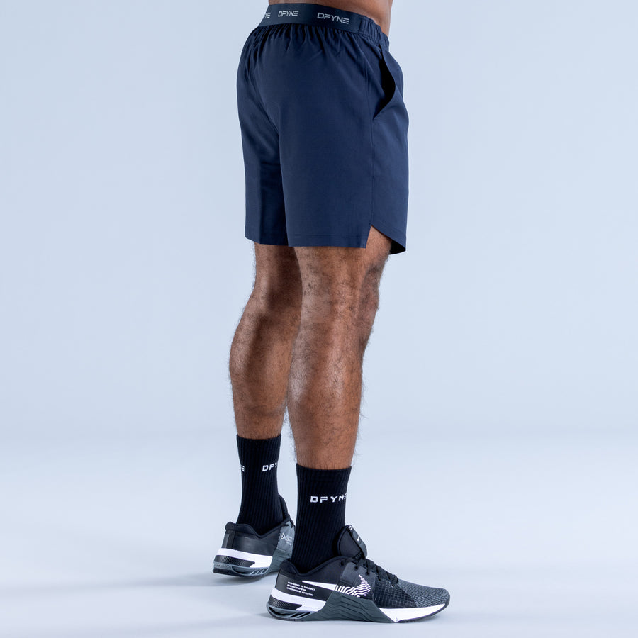 Navy training shorts with elastic waistband, side profile and above-knee cut