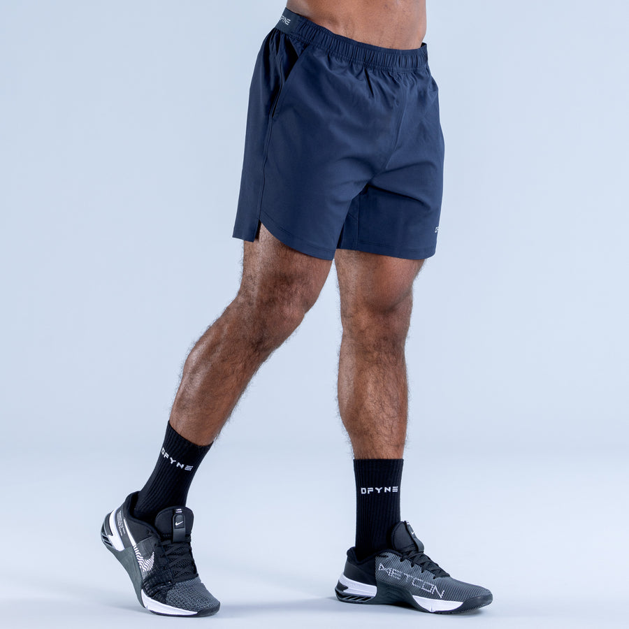 Navy training shorts with elastic waistband and side seam detail, above-knee