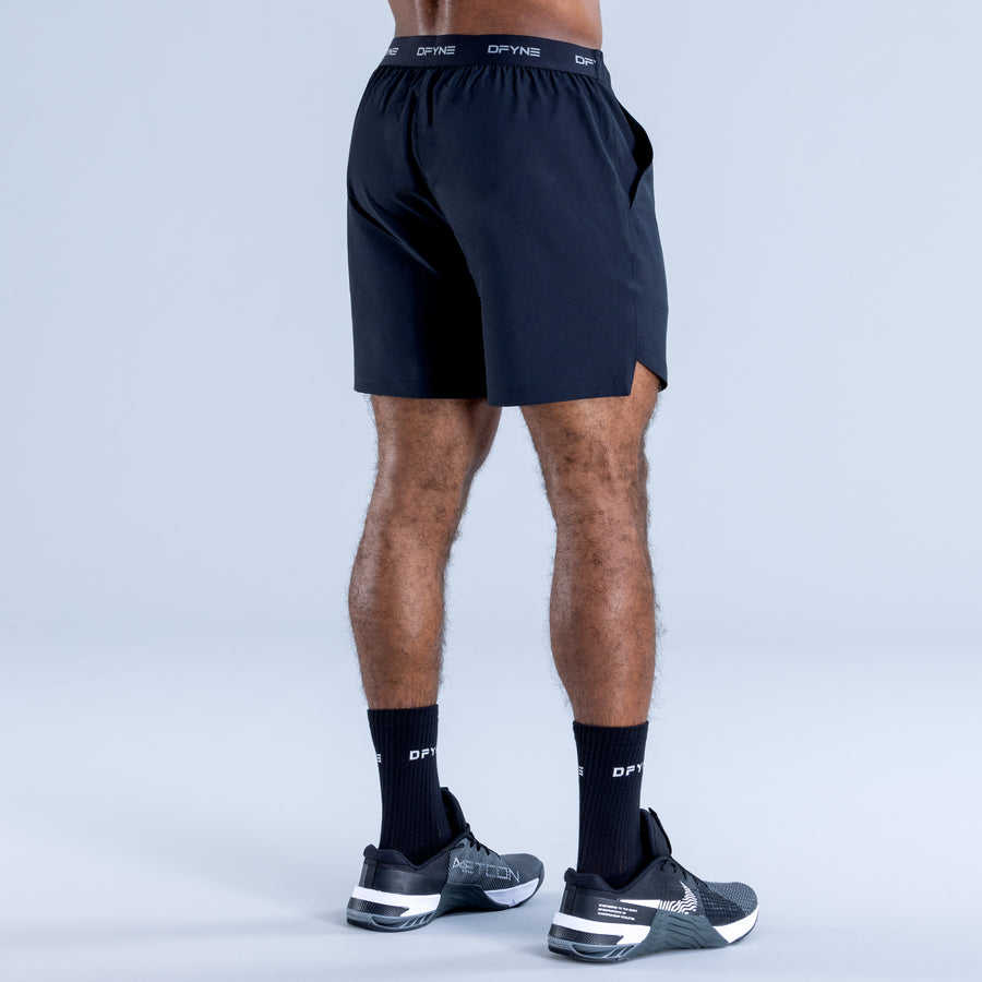 Training shorts, dark with elastic waistband and back waistband stripe detail.