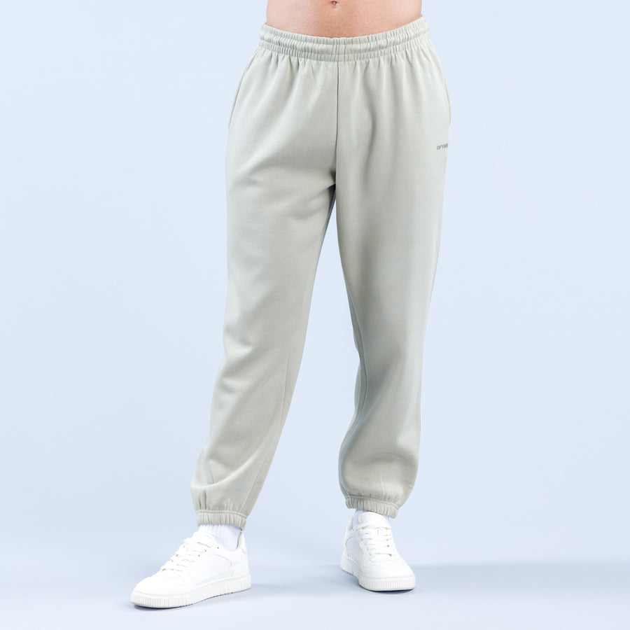 Light sage joggers with elastic waistband, tapered legs, and ankle cuffs.
