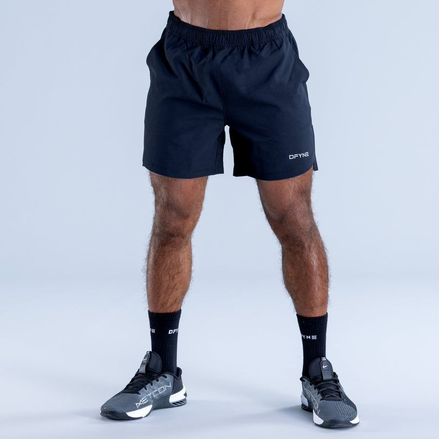 Training shorts, dark with elastic waistband and small thigh logo detail.