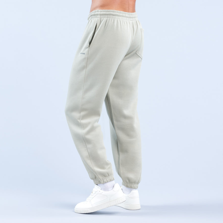Light sage joggers with elastic waistband and ankle cuffs, side view.