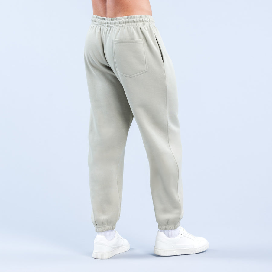 Light sage joggers with front pockets, elastic waistband, and ankle cuffs.