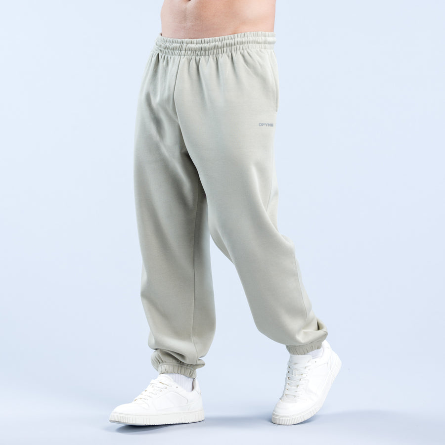 Light sage joggers with elastic waistband and ankle cuffs, logo on thigh.