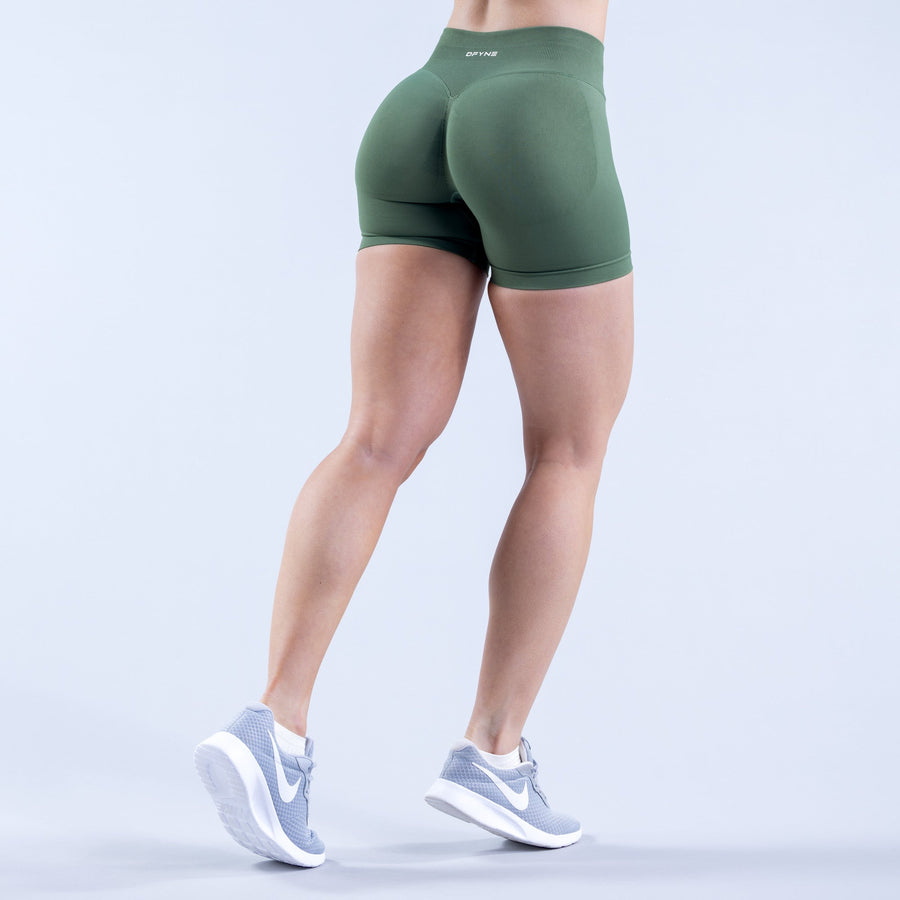 Fitted green athletic impact shorts back view with mid-thigh length and snug fit