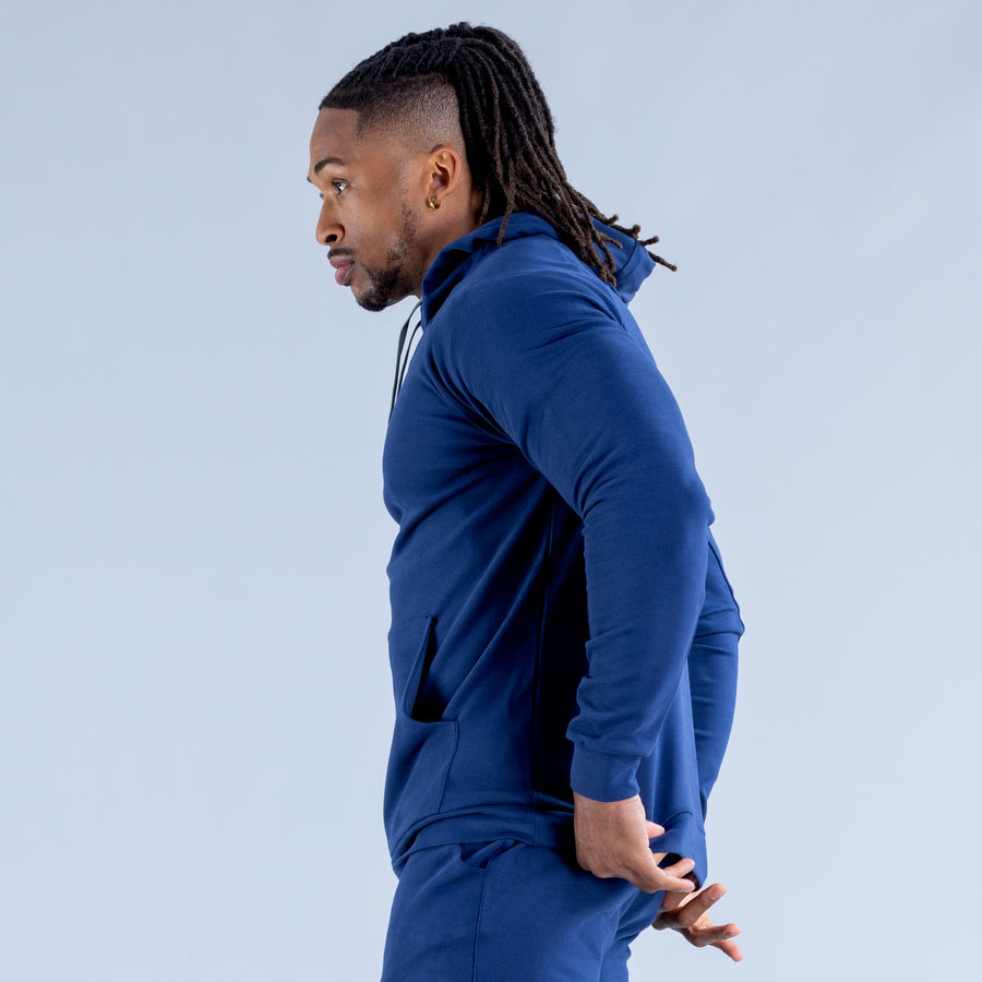 Midweight blue pullover hoodie, side view, with hood and front kangaroo pocket
