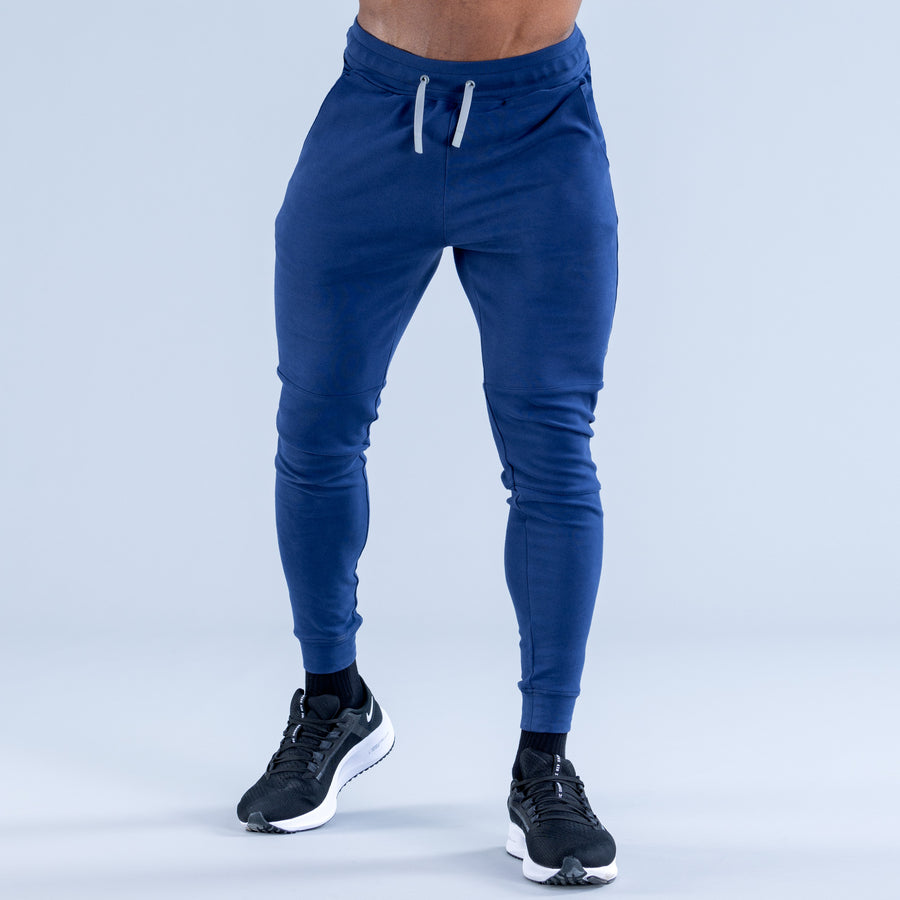 Blue tapered jogger pants with drawstring waistband and elastic ankle cuffs