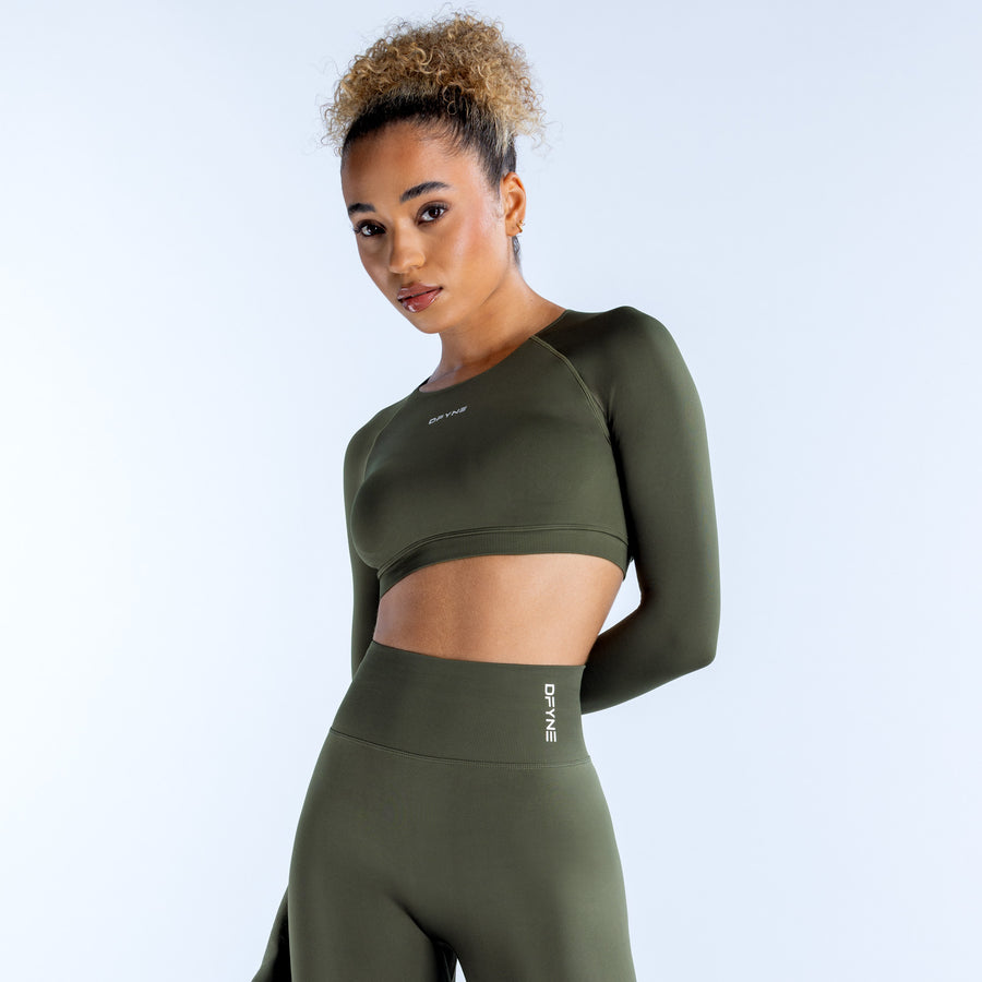 Olive green long-sleeve crop top with fitted waist seam and small side logo