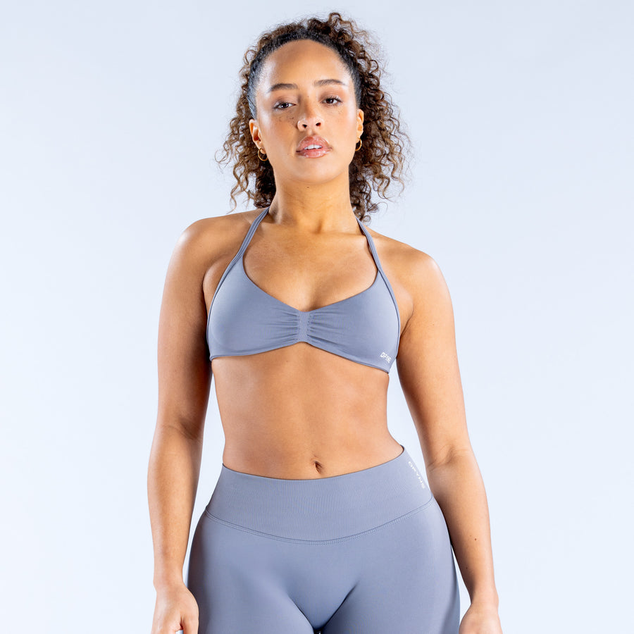 Impact strappy sports bra in blue-gray with ruched front and thin crossover straps
