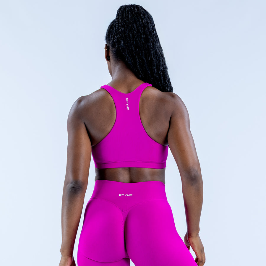 Magenta racerback sports bra with high neckline, showing full back view