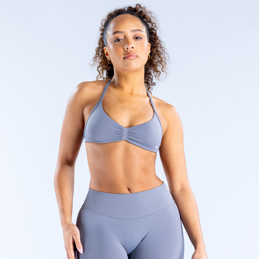 Impact strappy sports bra in blue-gray with ruched cups and thin crossover straps