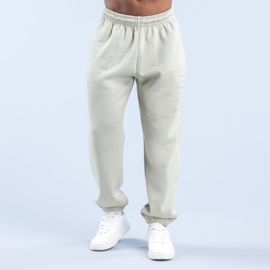 Cream graphic jogger pants with elastic waistband, jogger cuffs, and side graphic