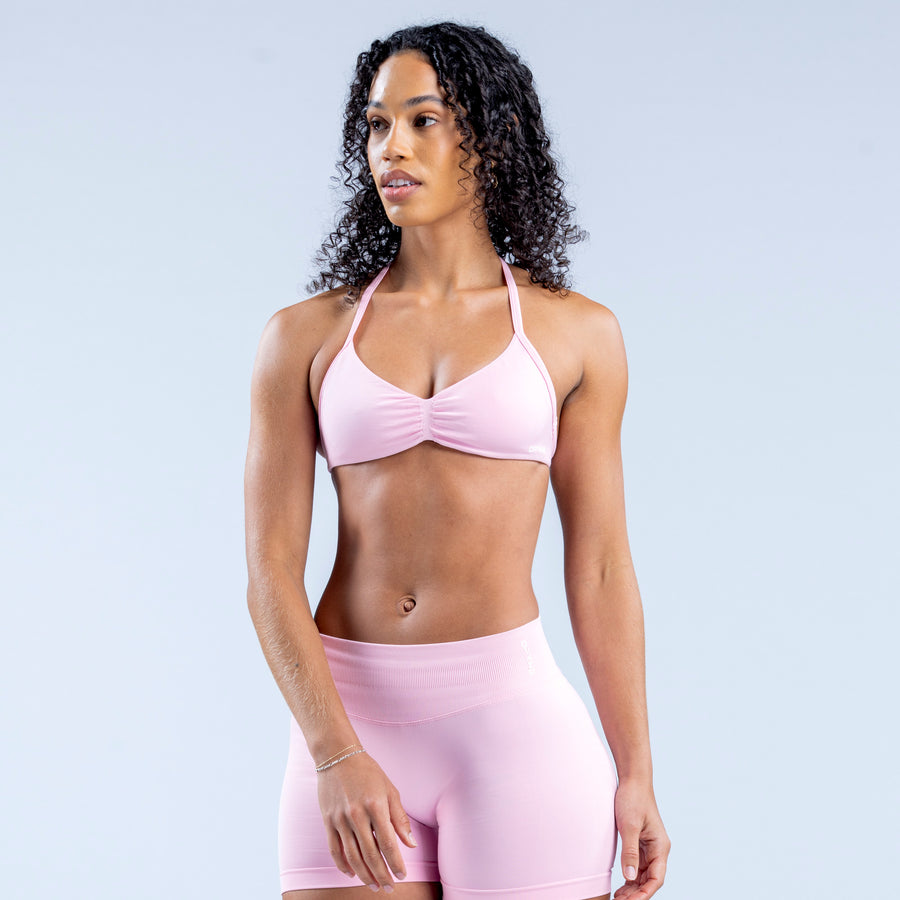 Light pink strappy bra with ruched center and matching high-waist bottoms