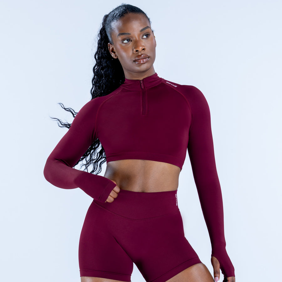 Burgundy long-sleeve crop top with quarter zip and matching shorts