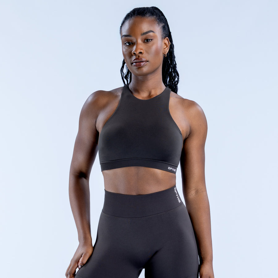 Women's black racerback sports bra with high neck and small logo at center