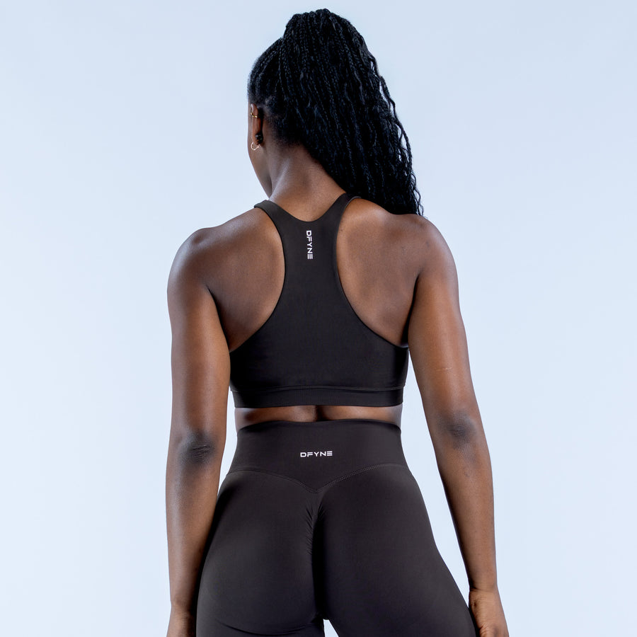 Women's black racerback sports bra with racerback straps and smooth back panel
