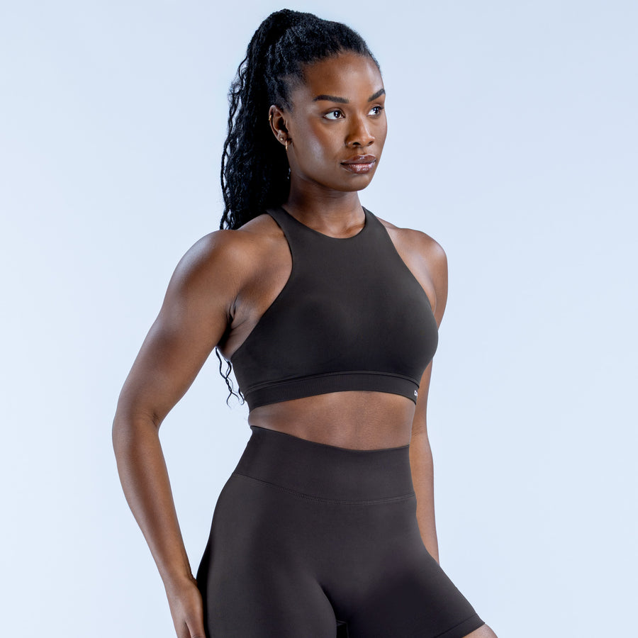 Women's black racerback sports bra with high neckline and seamless stretch fit