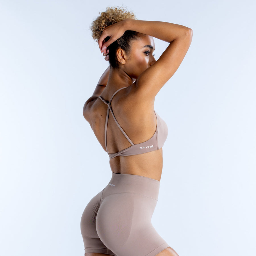 Taupe sports bra with crisscross back straps and racerback coverage