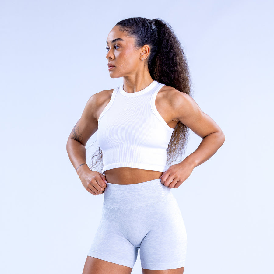 White racerback crop top with high neckline and sleeveless cut