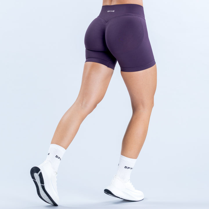 Purple 4.5-inch fitted shorts with a wide high-rise waistband, back view.